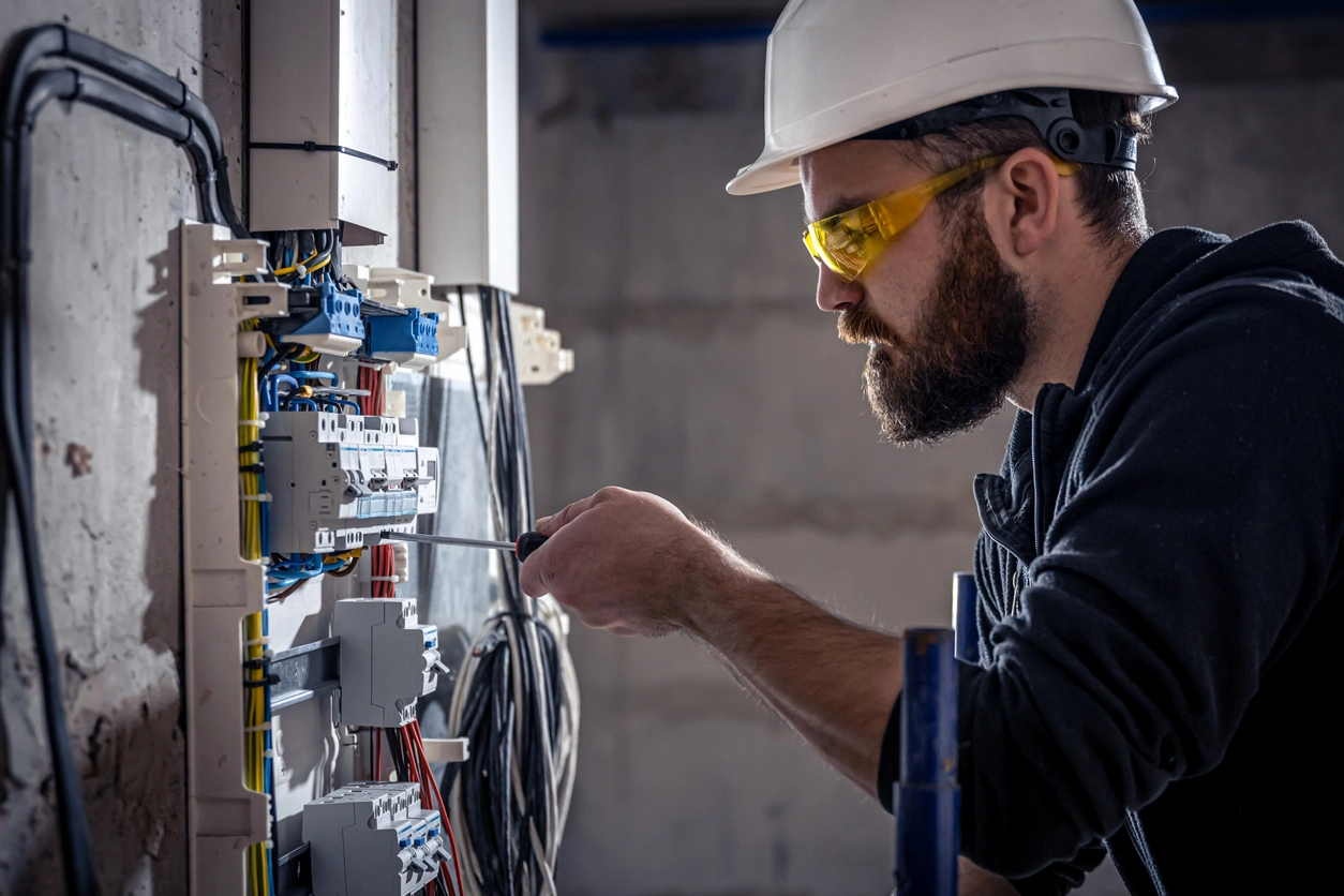 Electrician working on electrical panel